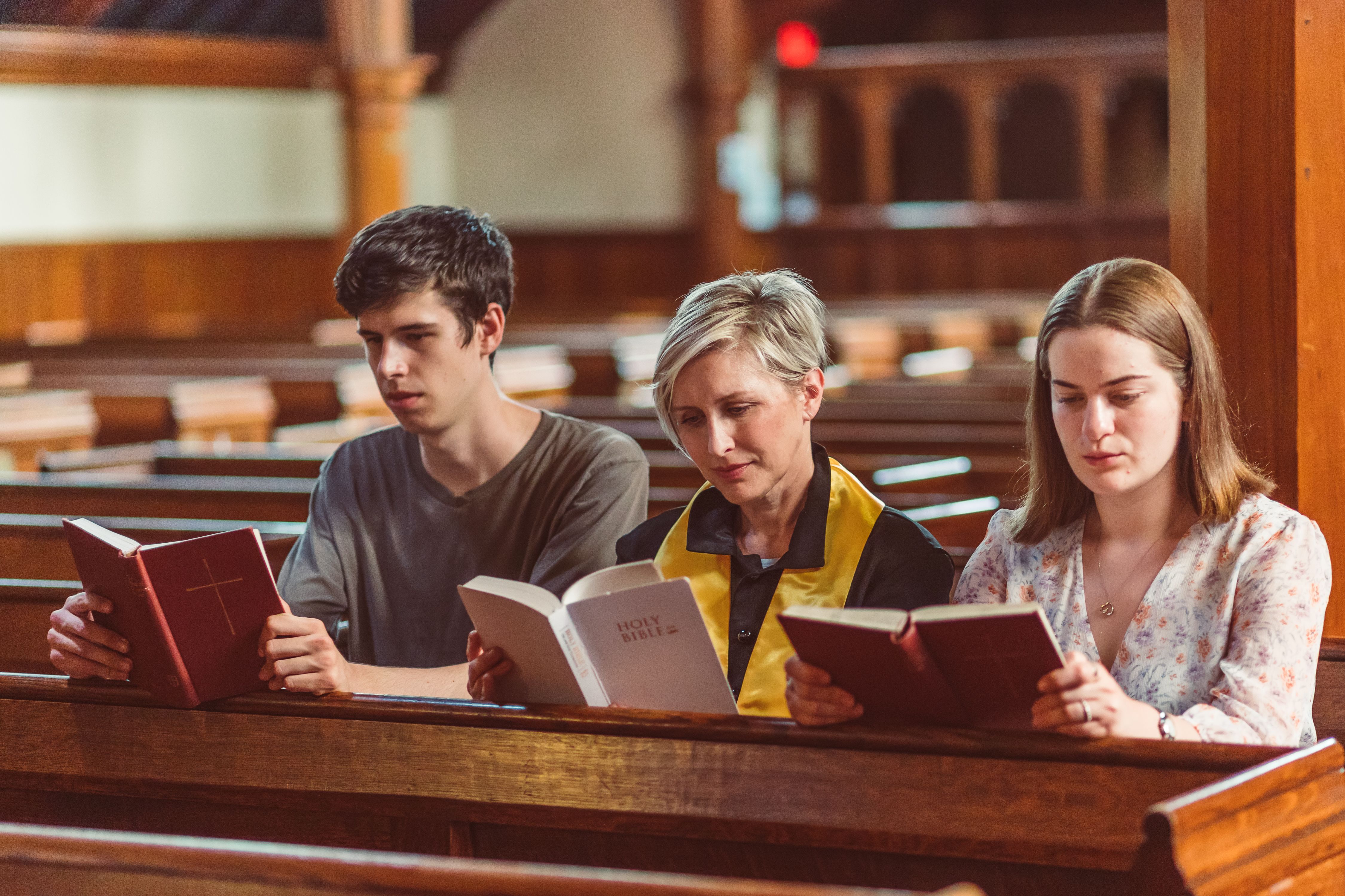 A Family reading their Bibles in Church