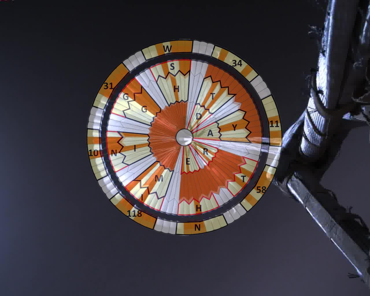 Perseverance's parachute fully inflated against the Martian sky, its canopy divided into red and white segments in an irregular ring pattern.